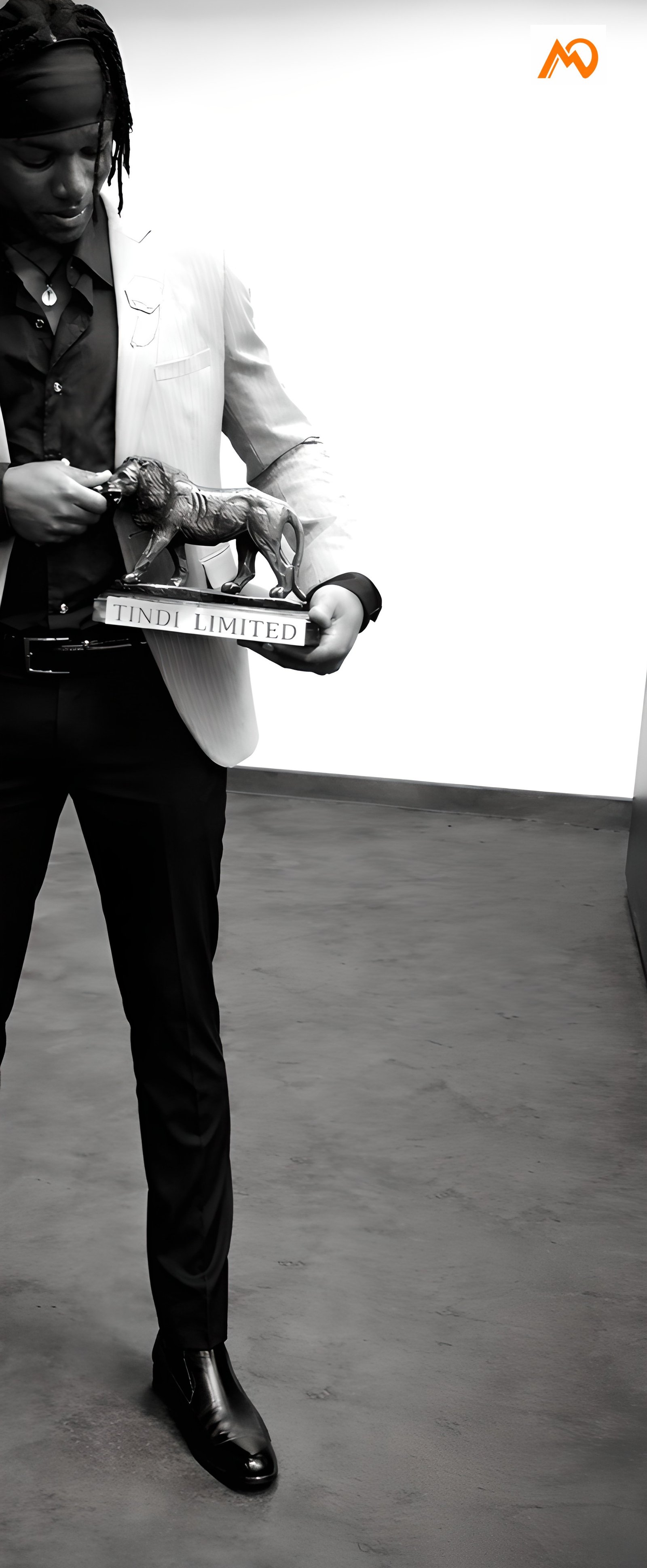 Emmanuel Okola holding a Tindi trophy